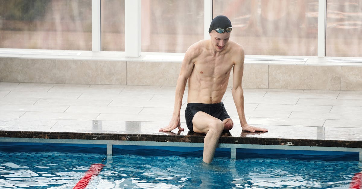 Photo Of Man Sitting Beside Pool